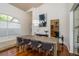 Formal dining area with modern lighting, wood floors, and an adjacent view of the kitchen at 1903 Curry Rd, Lutz, FL 33549