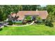 Charming single-story home with manicured lawn, mature landscaping, and a welcoming entryway at 1903 Curry Rd, Lutz, FL 33549