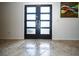 Welcoming foyer features modern tile inlay and frosted glass front doors for a touch of elegance at 1903 Curry Rd, Lutz, FL 33549