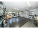 Spacious garage with rubber flooring, shelving, and mirror, ready to be turned into a home gym at 1903 Curry Rd, Lutz, FL 33549