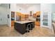 Spacious kitchen with a large center island, stainless steel appliances, and light wood cabinets at 1903 Curry Rd, Lutz, FL 33549