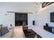Bright living room with sliding barn doors, comfortable seating, and a modern entertainment center at 1903 Curry Rd, Lutz, FL 33549