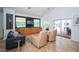 Comfortable living room with a built-in entertainment center, tile floors, and access to the pool area at 1903 Curry Rd, Lutz, FL 33549