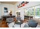 Bright and airy living area with hardwood floors, large windows, and seamless access to the outdoor pool area at 1903 Curry Rd, Lutz, FL 33549