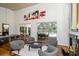 Spacious living room with vaulted ceilings, wood floors, and a view of the outdoor pool area at 1903 Curry Rd, Lutz, FL 33549