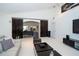 Spacious living room with a vaulted ceiling, stylish furniture, and dark sliding doors at 1903 Curry Rd, Lutz, FL 33549