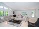 Bright and airy living room with neutral tones, large windows, and modern furniture at 1903 Curry Rd, Lutz, FL 33549