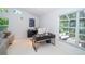 Home office with natural light, modern desk, and comfortable seating area at 1903 Curry Rd, Lutz, FL 33549