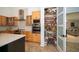 Well-stocked pantry with shelving and easy access from the kitchen at 1903 Curry Rd, Lutz, FL 33549
