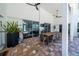 Covered patio with large table and chairs overlooks the pool through sliding glass doors at 1903 Curry Rd, Lutz, FL 33549