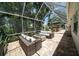Covered patio with comfortable seating and string lights, perfect for entertaining or relaxing outdoors at 1903 Curry Rd, Lutz, FL 33549