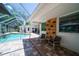 Inviting pool area with seating and lush landscaping, creating a private backyard oasis at 1903 Curry Rd, Lutz, FL 33549