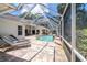 Spacious screened-in pool area with lounge chairs, ideal for relaxation and entertainment at 1903 Curry Rd, Lutz, FL 33549