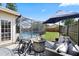 Backyard patio with a fire pit, outdoor seating, and view of the screened-in pool at 1914 Elk Spring Dr, Brandon, FL 33511
