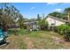 Spacious backyard with a screened-in pool area, lush landscaping, and play equipment at 1914 Elk Spring Dr, Brandon, FL 33511