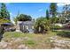 Spacious backyard featuring a screened-in pool, patio furniture, and lush landscaping at 1914 Elk Spring Dr, Brandon, FL 33511