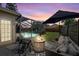 Backyard patio with fire pit, comfortable seating, and view of the screened-in pool at 1914 Elk Spring Dr, Brandon, FL 33511