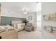 Cozy Bedroom with a crib, glider chair, and soft color palette, creating a peaceful atmosphere at 1914 Elk Spring Dr, Brandon, FL 33511