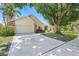 Traditional home with a large driveway, a well-manicured lawn and mature landscaping at 1914 Elk Spring Dr, Brandon, FL 33511