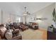 Comfortable living room featuring plush leather sofas, modern decor, and a stylish ceiling fan at 1914 Elk Spring Dr, Brandon, FL 33511