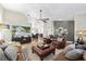 Open-concept living room with hardwood floors, stylish furniture, and a modern entertainment center with large TV at 1914 Elk Spring Dr, Brandon, FL 33511
