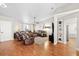Bright living room with hardwood floors, vaulted ceiling, and a comfortable seating arrangement perfect for entertaining at 1914 Elk Spring Dr, Brandon, FL 33511