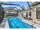Screened pool area with lounge chairs, lush landscaping, and a view of the backyard at 1914 Elk Spring Dr, Brandon, FL 33511