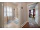 Bright bathroom with shower-tub combination and adjacent hallway at 204 E North St, Tampa, FL 33604