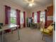 Spacious bedroom featuring neutral carpet, large windows, and a ceiling fan at 204 E North St, Tampa, FL 33604