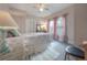 Cozy bedroom with natural light and neutral tones, featuring a ceiling fan and closet at 204 E North St, Tampa, FL 33604