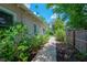 A brick paver pathway leads along the side of the house to a backyard pool, and lush landscaping at 204 E North St, Tampa, FL 33604
