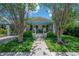 Charming home exterior with a welcoming front porch, blue accents, and well-manicured landscaping at 204 E North St, Tampa, FL 33604
