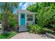Charming front entrance with a bright blue door and lush, tropical landscaping at 204 E North St, Tampa, FL 33604