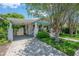 Inviting single-story home featuring a convenient carport, lush lawn, and inviting white and turquoise trim at 204 E North St, Tampa, FL 33604