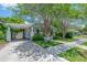 Inviting single-story home with a convenient carport, lush lawn, and inviting white and turquoise trim at 204 E North St, Tampa, FL 33604