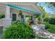 Charming front porch with colorful plants, comfortable seating, and classic white and turquoise trim at 204 E North St, Tampa, FL 33604