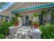 Charming front porch adorned with lush greenery and stylish white and turquoise accents at 204 E North St, Tampa, FL 33604