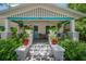 Charming front porch adorned with lush greenery and stylish white and turquoise accents at 204 E North St, Tampa, FL 33604