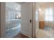 Hallway view leading into a bedroom and an adjacent bathroom with a window at 204 E North St, Tampa, FL 33604