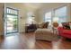 Bright living room with hardwood floors, a chaise lounge and an outdoor view at 204 E North St, Tampa, FL 33604