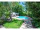 Private backyard oasis featuring a sparkling pool, surrounded by lush greenery and patio space at 204 E North St, Tampa, FL 33604