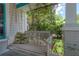 Relaxing front porch swing with comfortable pillow and lush greenery creating a serene ambiance at 204 E North St, Tampa, FL 33604