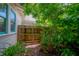 Enclosed backyard area features a gate for privacy, lush greenery, and garden at 204 E North St, Tampa, FL 33604