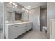Sleek, modern bathroom with double vanity, large mirror, and gray tile at 205 5Th N Ave # 501, St Petersburg, FL 33701