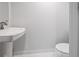 Powder room with tile flooring features a pedestal sink and modern toilet at 205 5Th N Ave # 501, St Petersburg, FL 33701