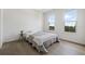 Cozy bedroom with hardwood floors, comfortable bed, and natural light at 205 5Th N Ave # 501, St Petersburg, FL 33701