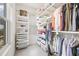Well-organized walk-in closet with shelving, hanging racks, and window for natural light to illuminate the space at 205 5Th N Ave # 501, St Petersburg, FL 33701
