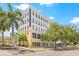 Attractive condominium building, Palladium Flats, featuring clean lines, neutral colors, and beautiful trees at 205 5Th N Ave # 501, St Petersburg, FL 33701