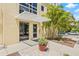 Inviting building entrance featuring glass doors, a modern awning, and lush landscaping at 205 5Th N Ave # 501, St Petersburg, FL 33701