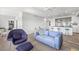 Inviting living room features a stylish blue sofa, unique arm chair, and modern kitchen in the background at 205 5Th N Ave # 501, St Petersburg, FL 33701